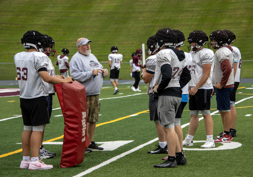 Coach Spange talking to players on the field