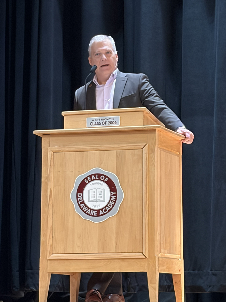 Carey Shultz speaks on stage