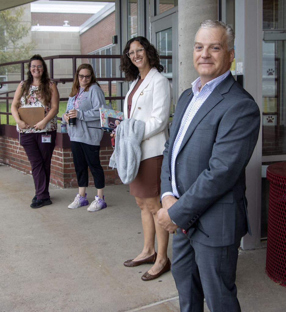 2 aides, Ms. Dutcher and Mr. Shultz greeted students at the elementary school