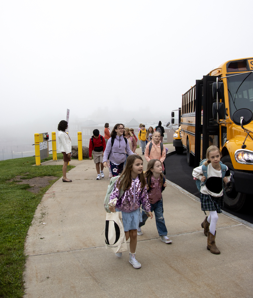 Ms. Dutcher ewatches as elementary students head into the school
