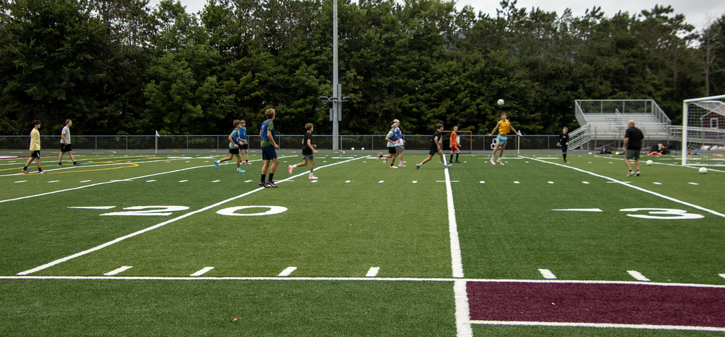 boys soccer players practicing on the field