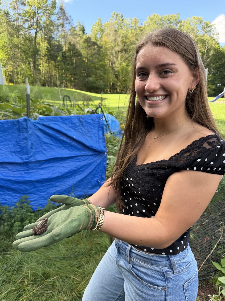 students shows off a toad she found working in the school garden