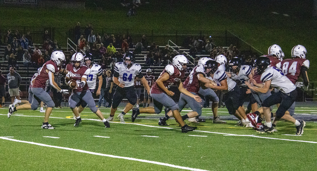 quaterback hands the ball off to running back