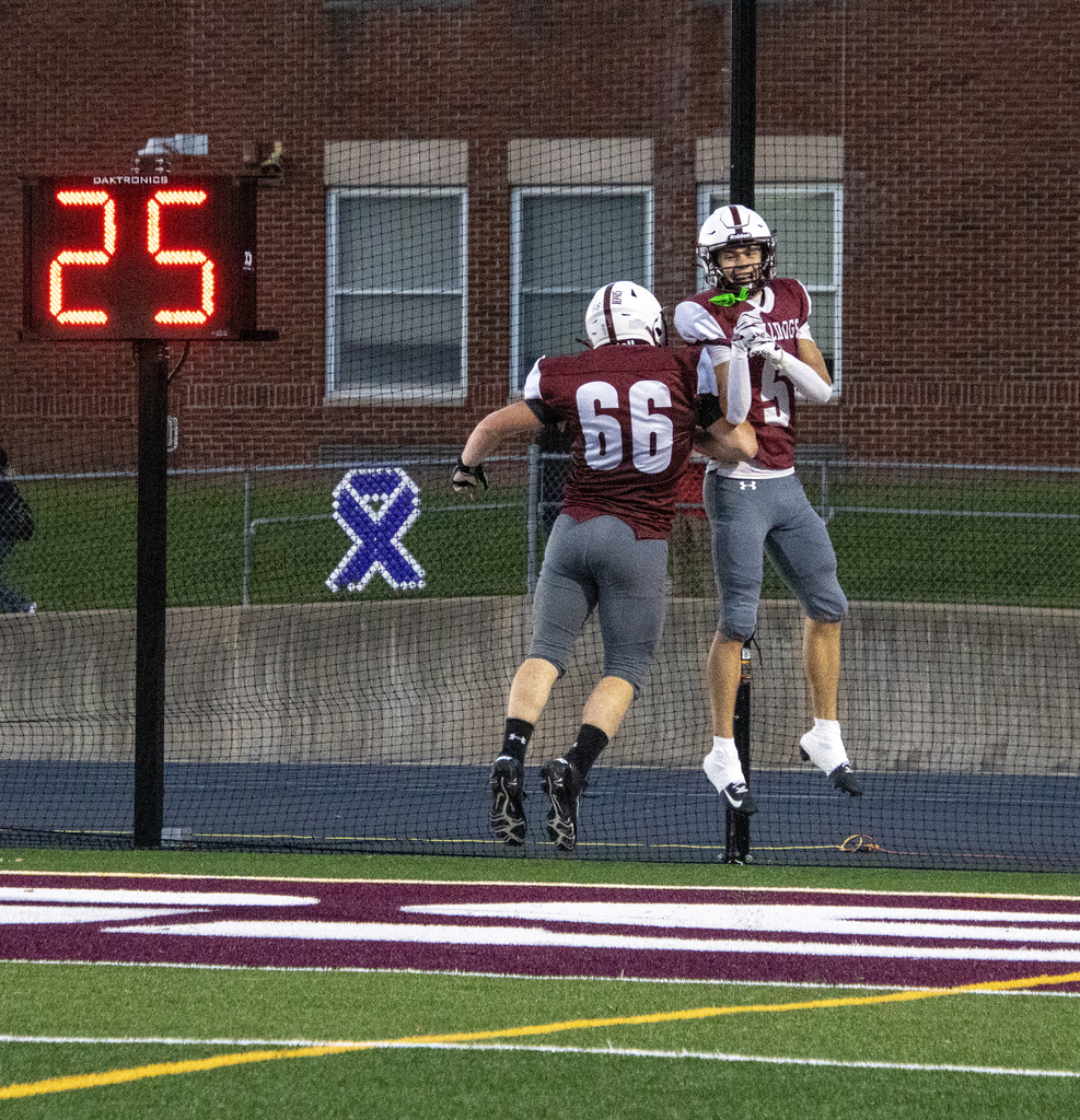 two players jump up for a celebratory chest bump