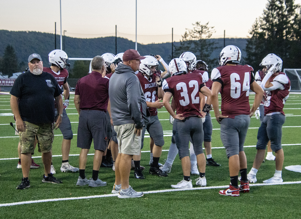 coaches talk to players on the field