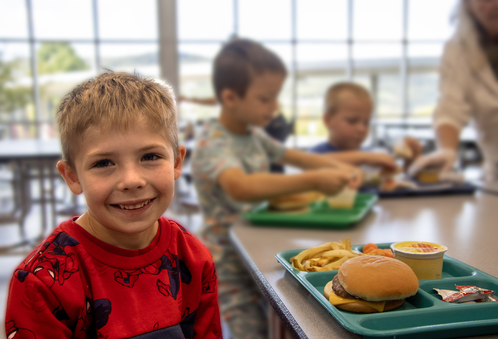 smiling boy at lunch table