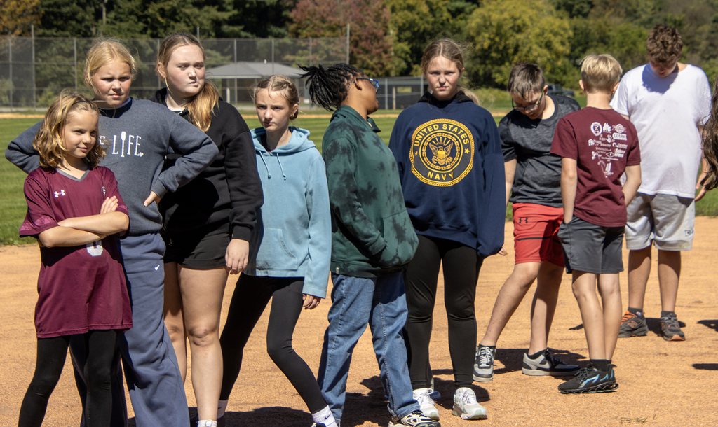 Students on a team stand in line, waiting for an activity to begin