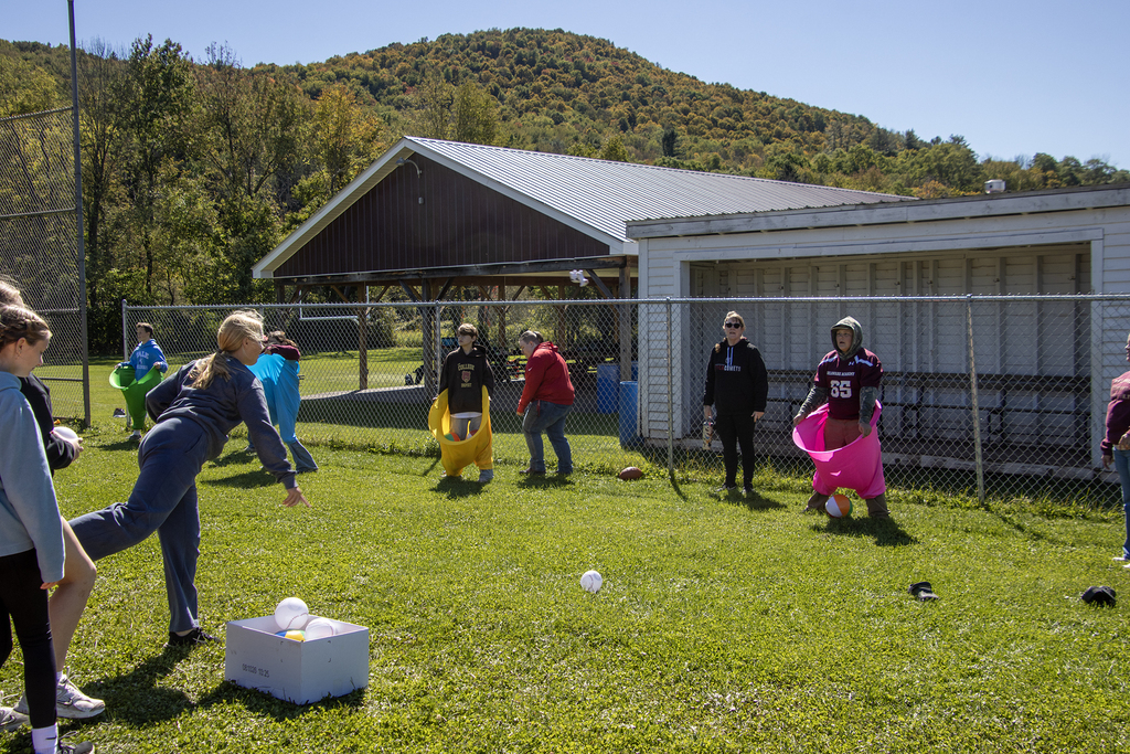 students throw balls at other students wearing large "granny pants" which they use to catch the balls