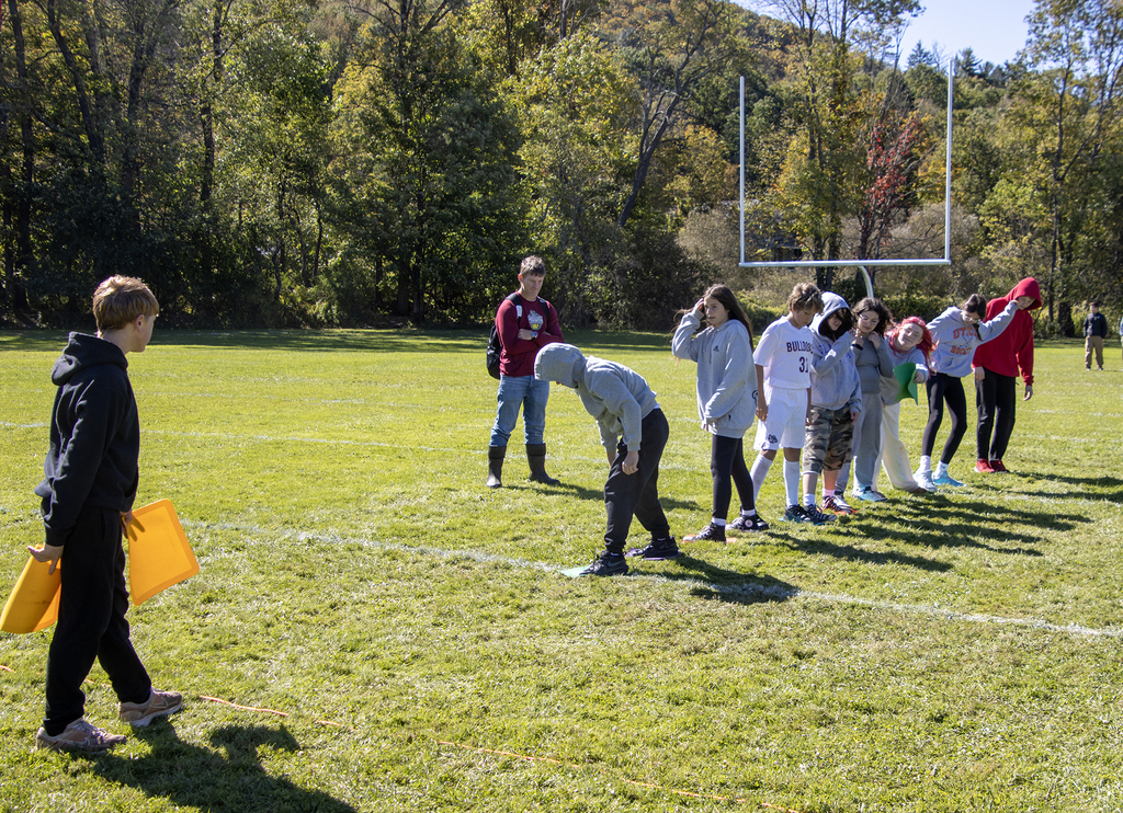 Mr. Abts watches as 7th grade students participate in a team building actiity