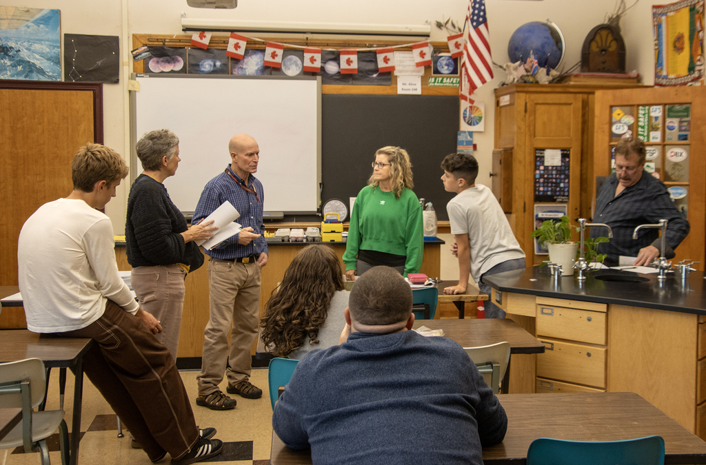 teacher talking to students and families in the classroom