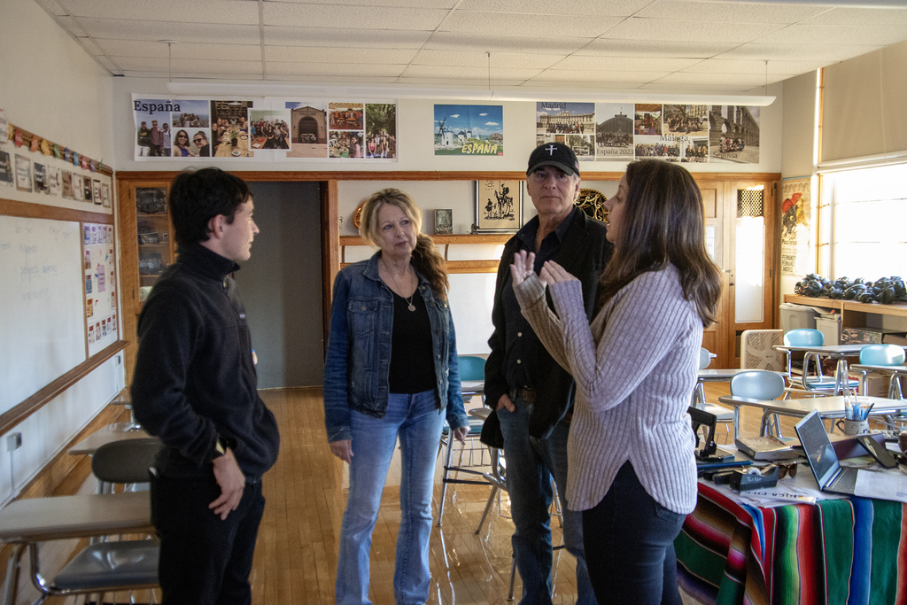 teacher talking to a student and family in the classroom