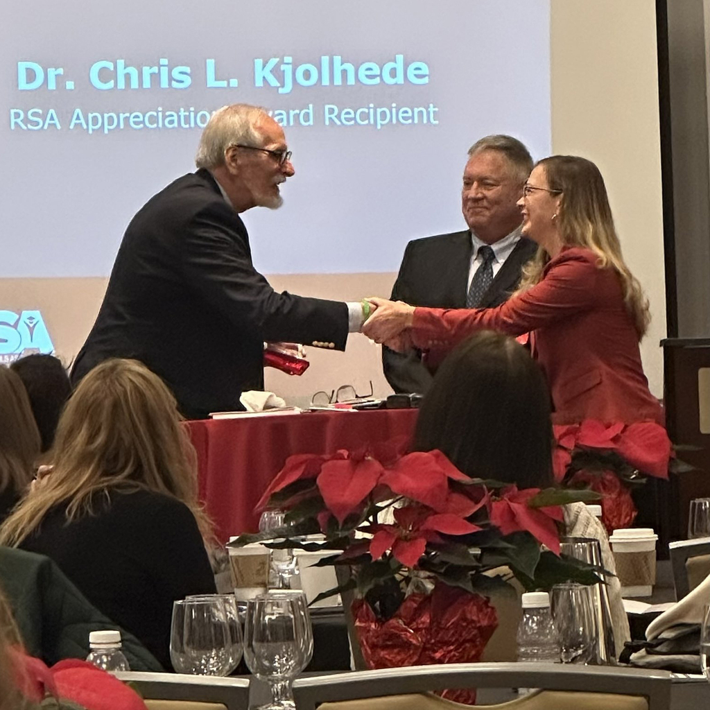 Dr. Chris Kjolhede receives the RAS Appreciation Award from Kelly Zimmerman