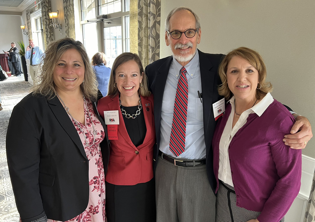 4 attendees at the conference are shown, including Kelly Zimmerman and Dr. Chris Kjohlhede