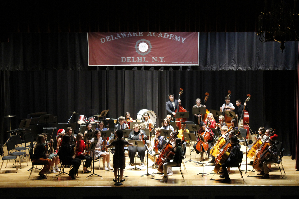 music teacher conducting the orchestra