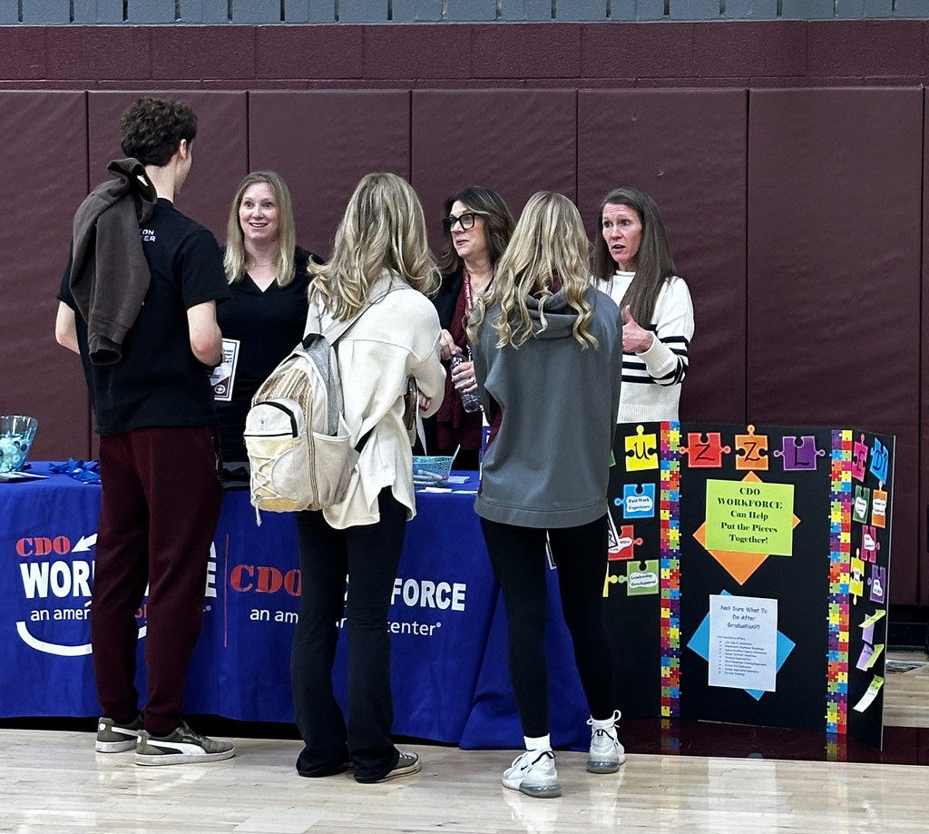 3 students talk to 3 adults at the career fair