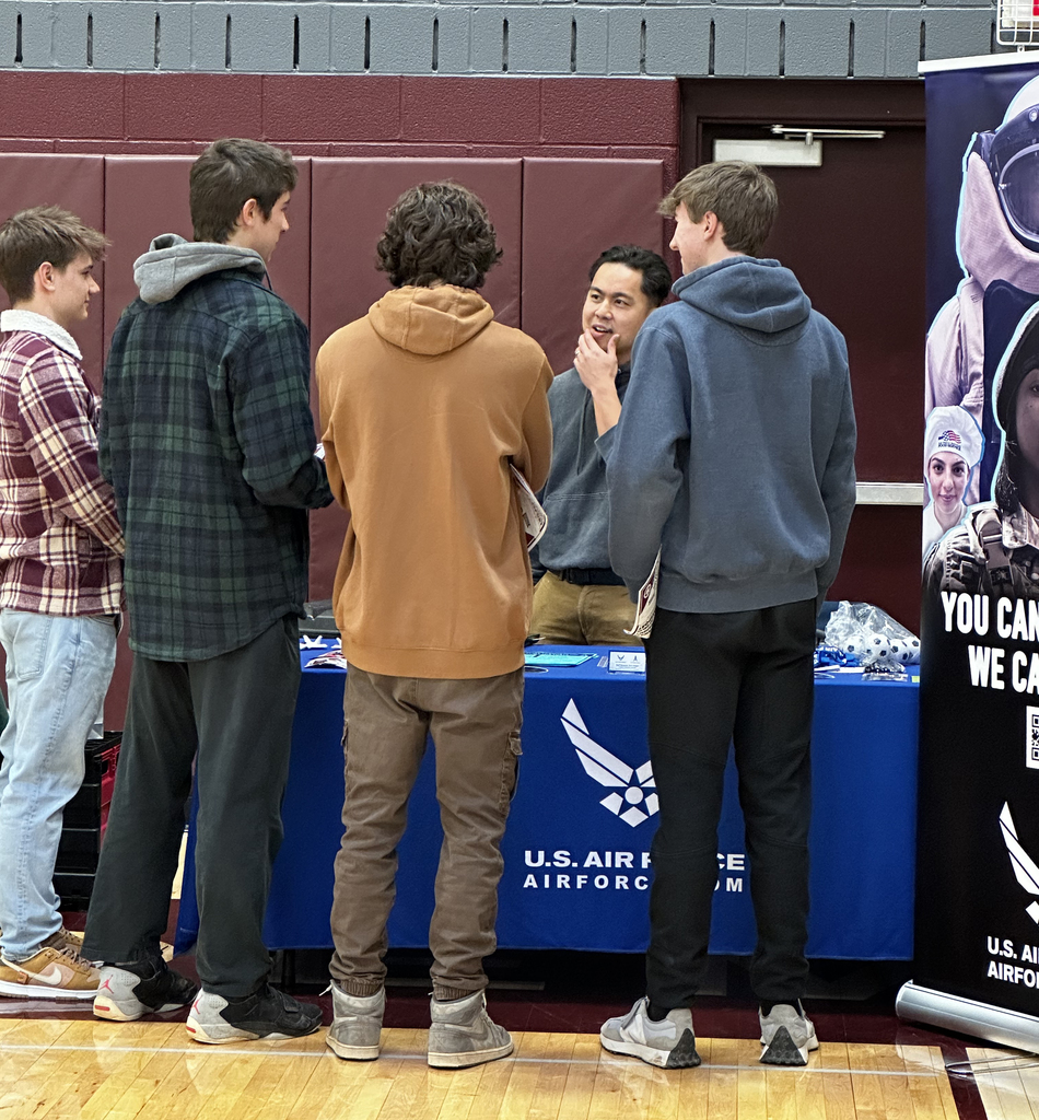 4 students talk to an adult at career fair