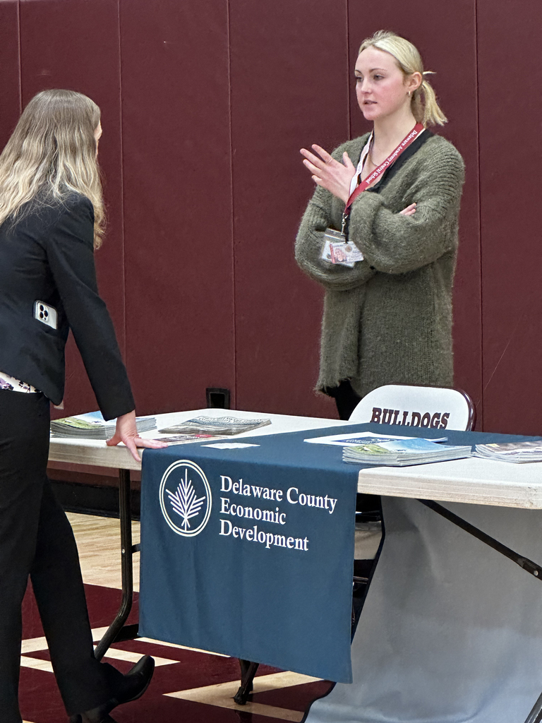 student talks to an adult at career fair