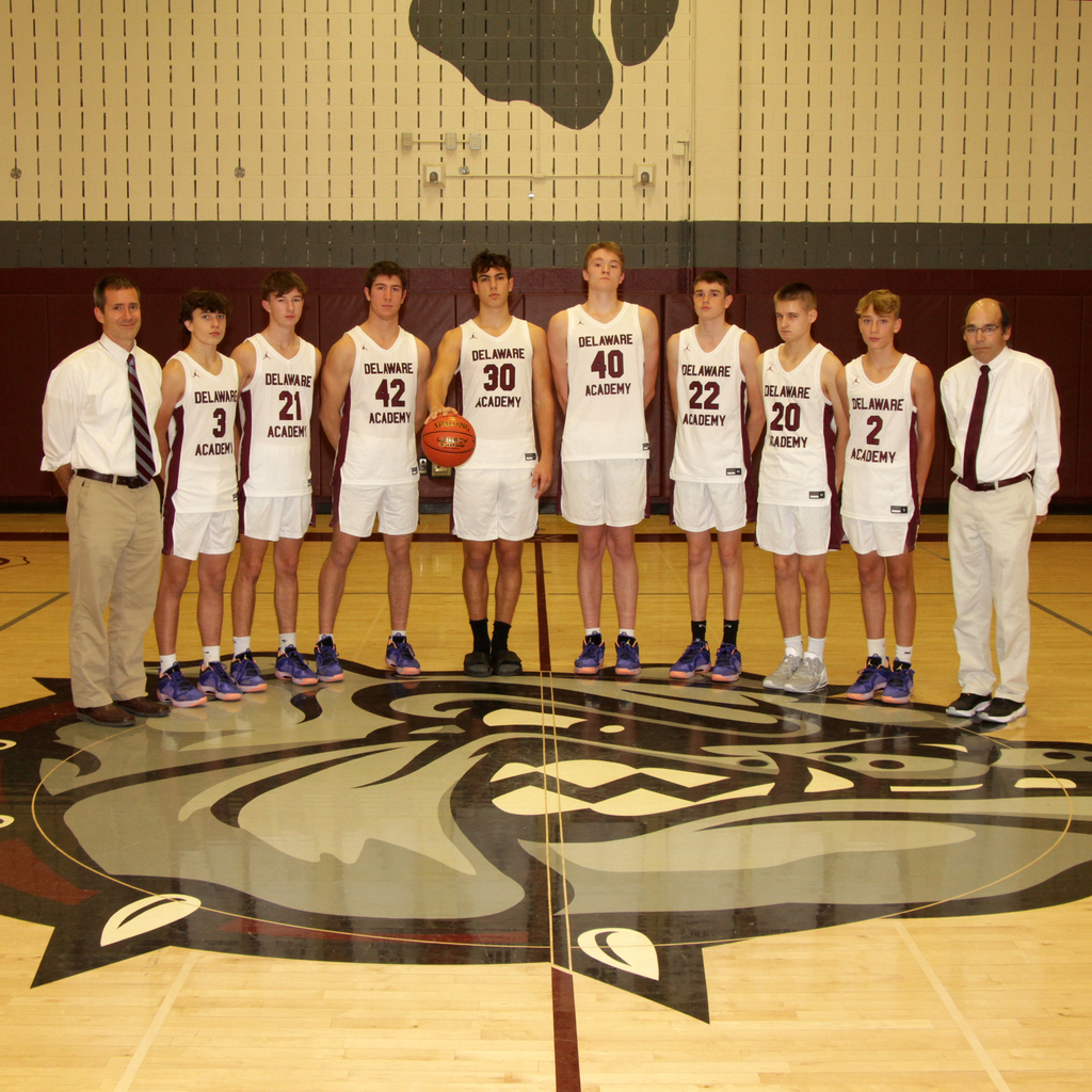 Boys varsity basketball team with two adult coaches
