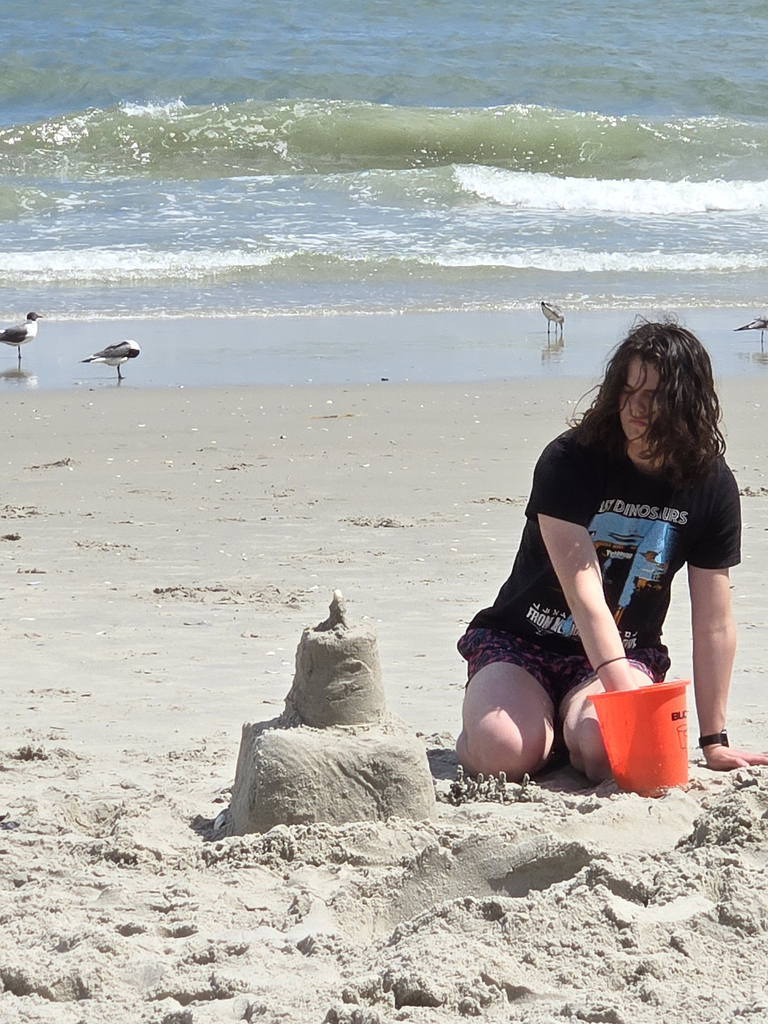 student making sand castle