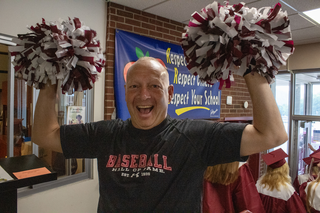 man waving pom poms