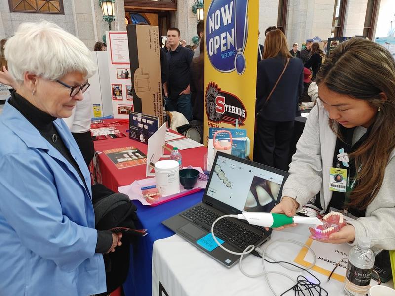 Dental Assisting student demonstrating equipment