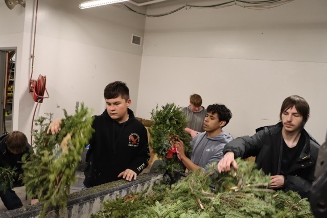 Students organizing wreaths