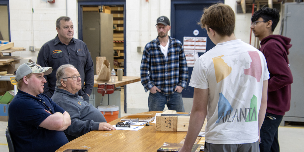 Ian Van Cott, Craig Van Cott and Lee Young from Unalam, Sidney NY, speak with students Jack Langstaff and Soleman Bhatti at the DCMO BOCES Applications Day last Tuesday  at Harrold Campus in Sidney Center. Carpentry & Building Construction instructor Matthew White looks on. 