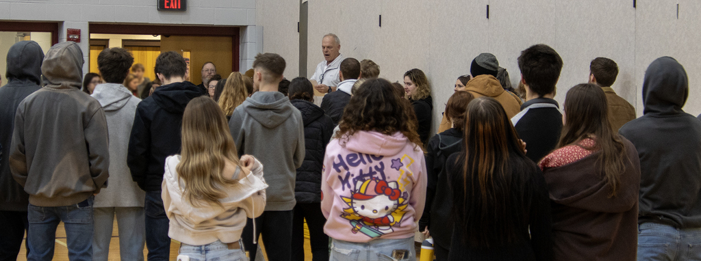 assistant principal speaks to crowd of visitng students