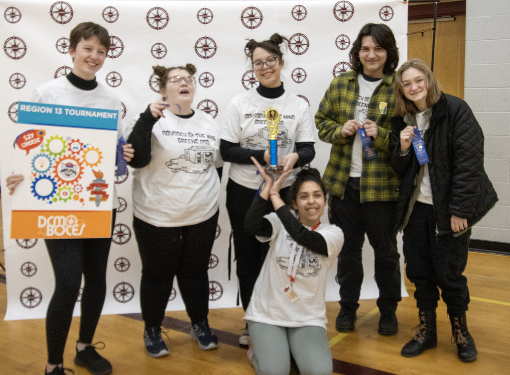 6 students with a trophy