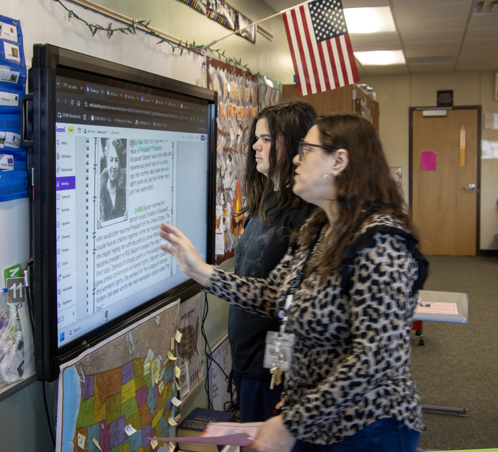 teacher works with student at screen