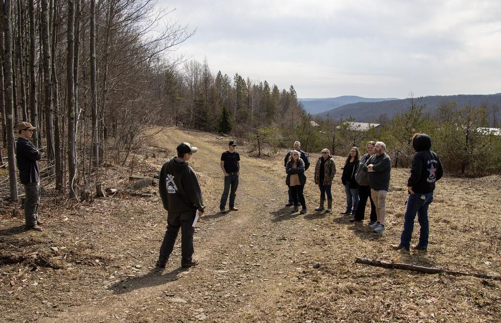 students talk about the sugarbush to visitors