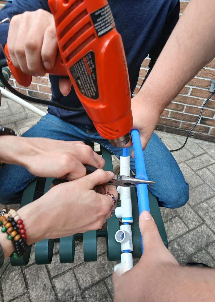 close up of snipping plastic pipe