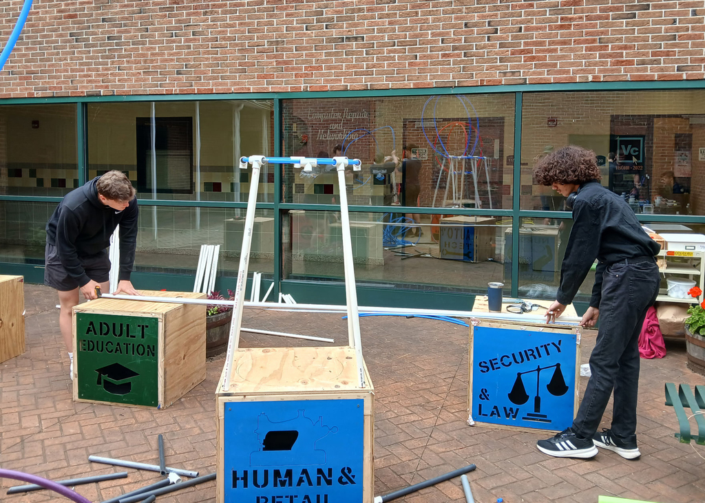 2 students work on their display project