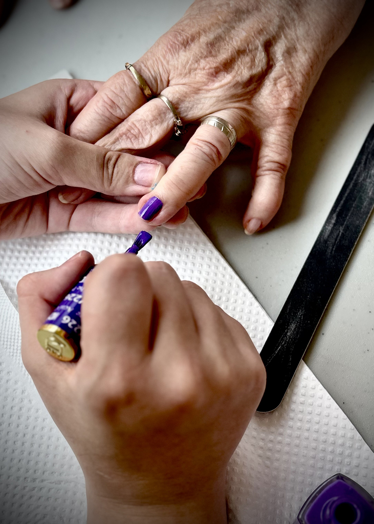purple nail polish being applied