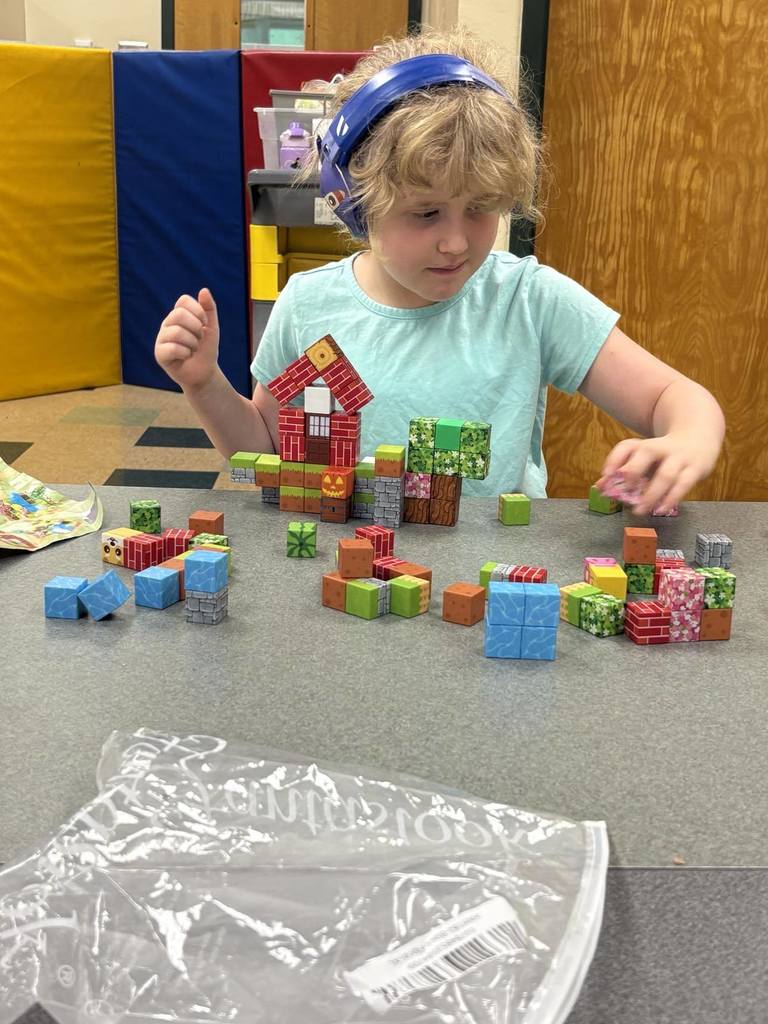 student playing with small plastic figures