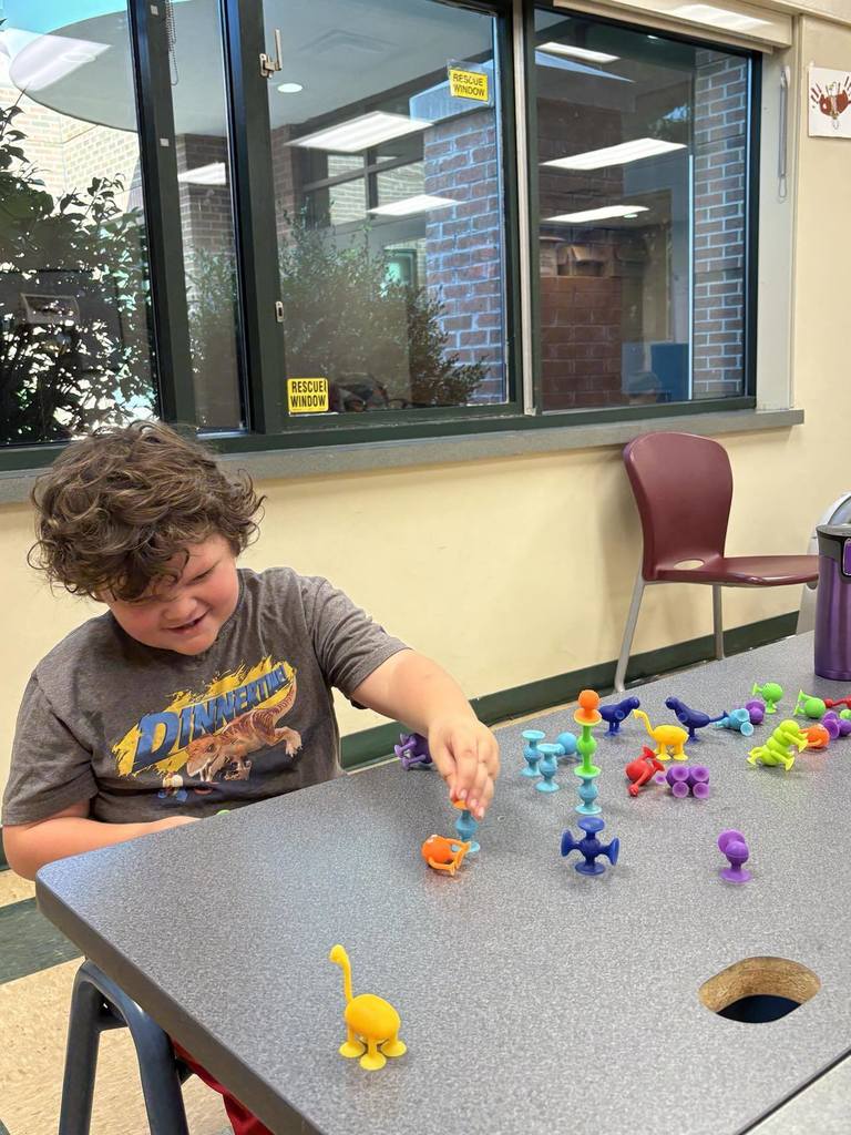 student playing with small plastic figures