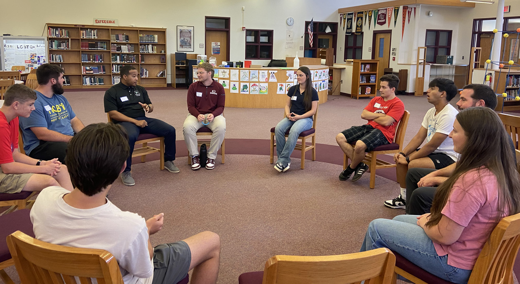 students talk in a circle