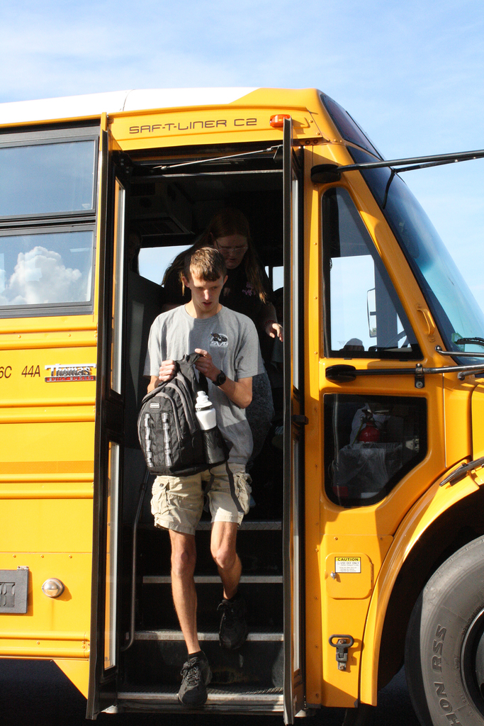 student getting off bus