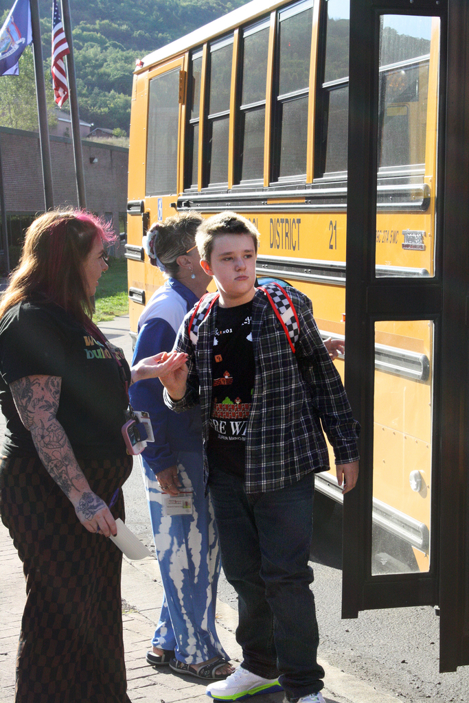 student getting off bus