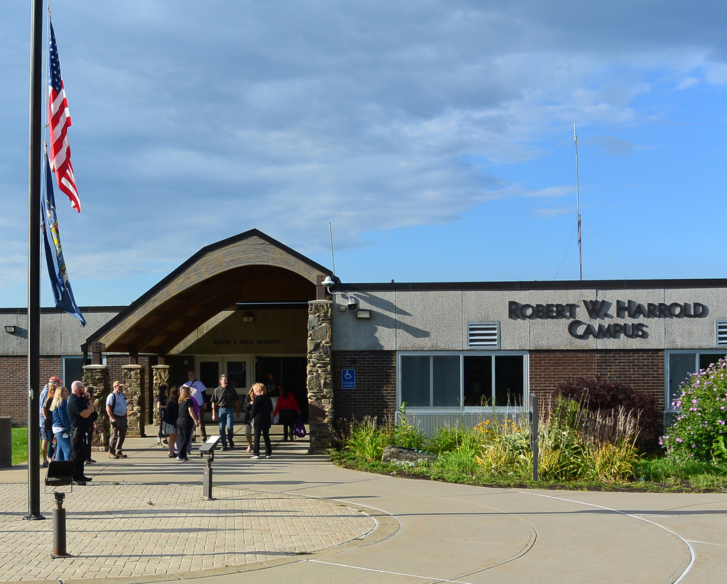 staff waiting in front of Robert W. Harold Campus
