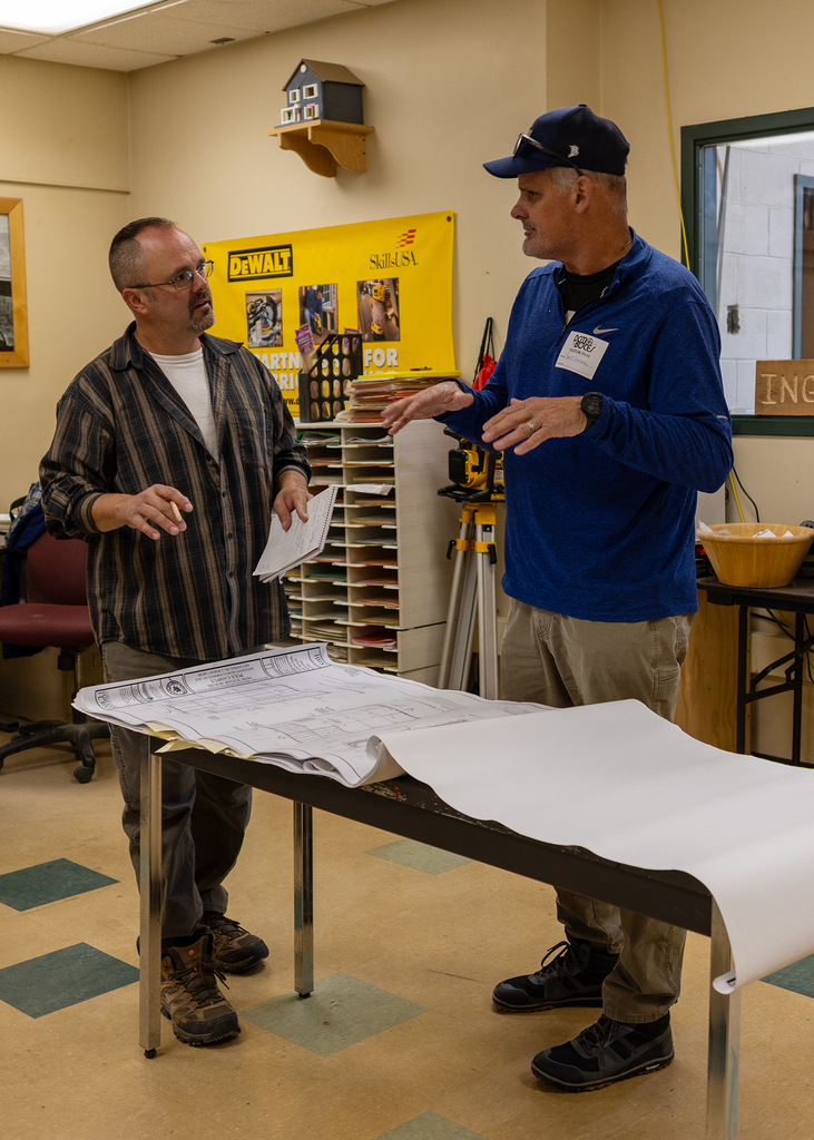 speaker and teacher talking about blueprints