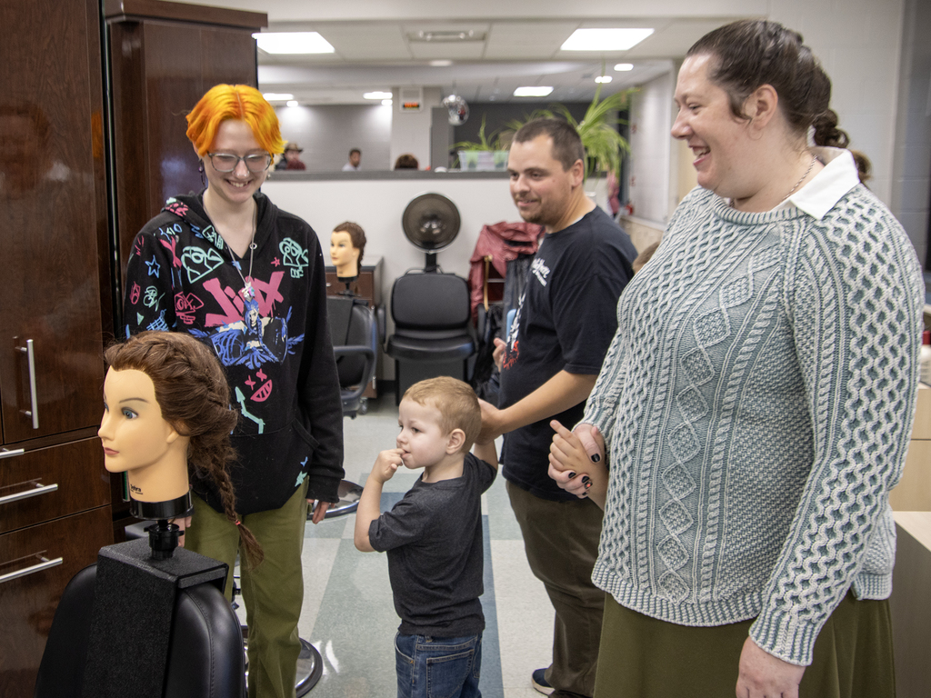 student and family looking at mannequin head