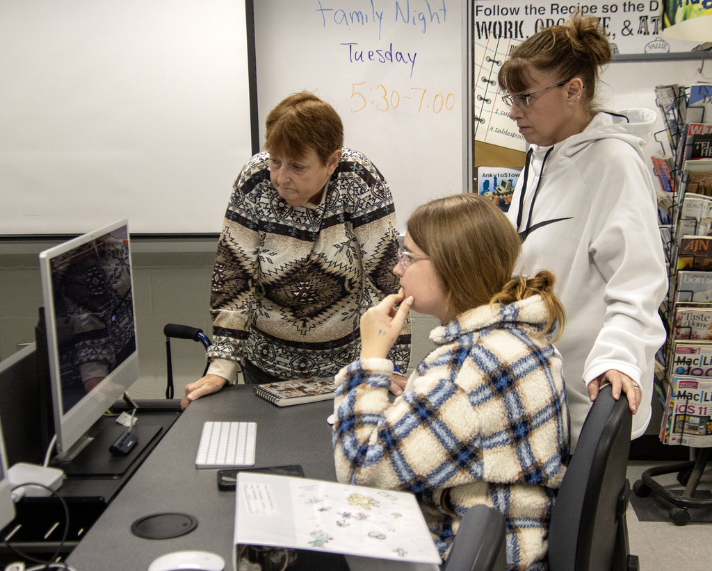 student and family looking at computer
