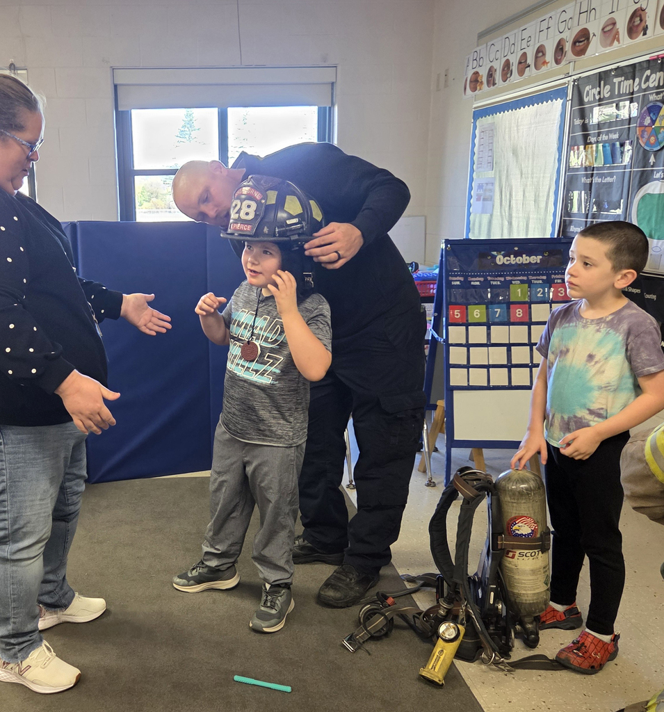 firefighter with students and teacher