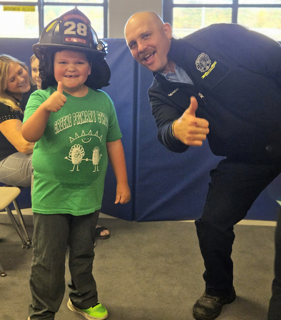 student and firefighter thumbs up