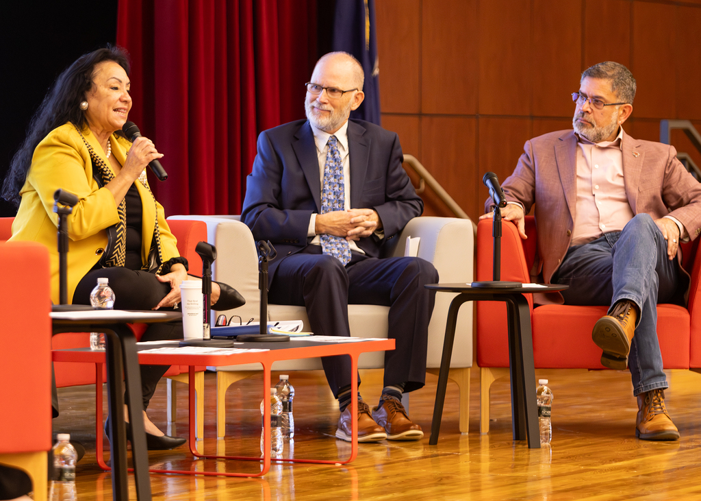Commissioner-Rosa and two men on stage