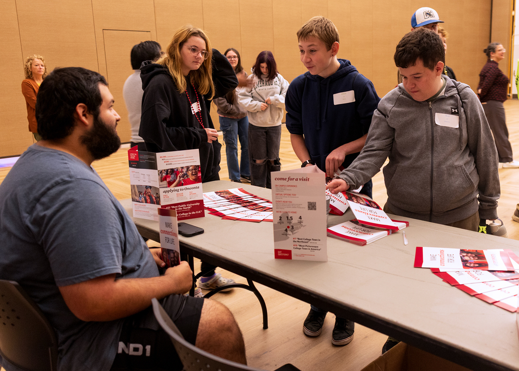 students at academic fair table