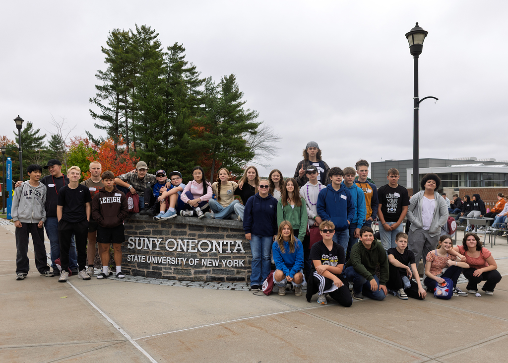 Hancock students pose at Oneonta sign