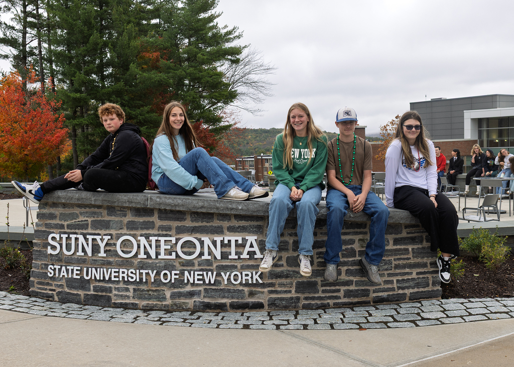 Deposit students pose at Oneonta sign
