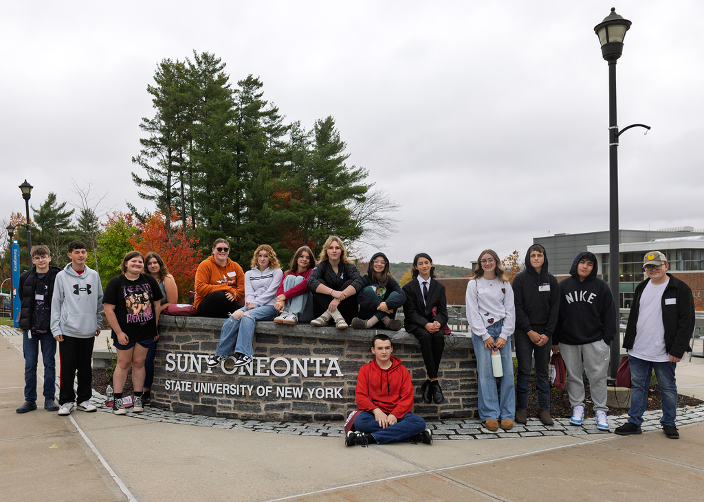 Charlotte Valley students pose at Oneonta sign